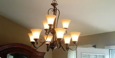Classic ceiling chandelier installation with warm lighting in Charlotte, NC