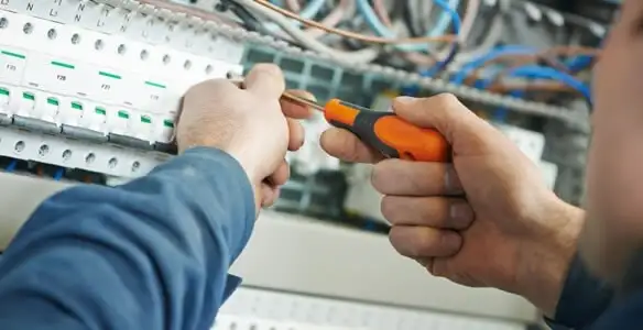 electrical service showing licensed electrician performing electrical panel maintenance and adjustments in Charlotte, NC