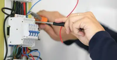 Electrician installing and adjusting circuit breakers in an electrical panel in Charlotte, NC