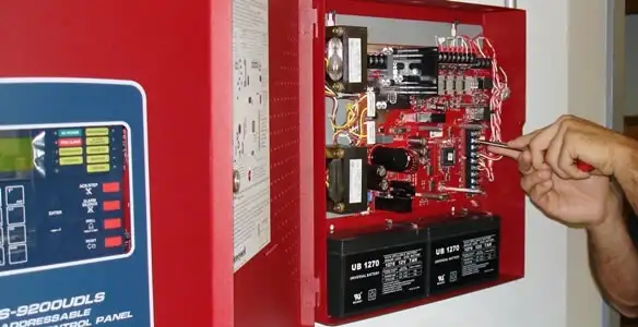fire alarm installation service showing technician configuring fire alarm control panel in Charlotte, NC