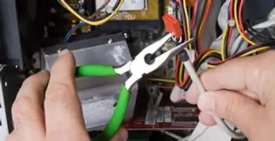 Licensed electrical contractor performing electrical repair with tools in Fort Mill, SC