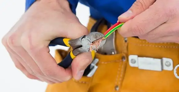 licensed electrician securing electrical wiring with professional tools during service work in Charlotte, NC